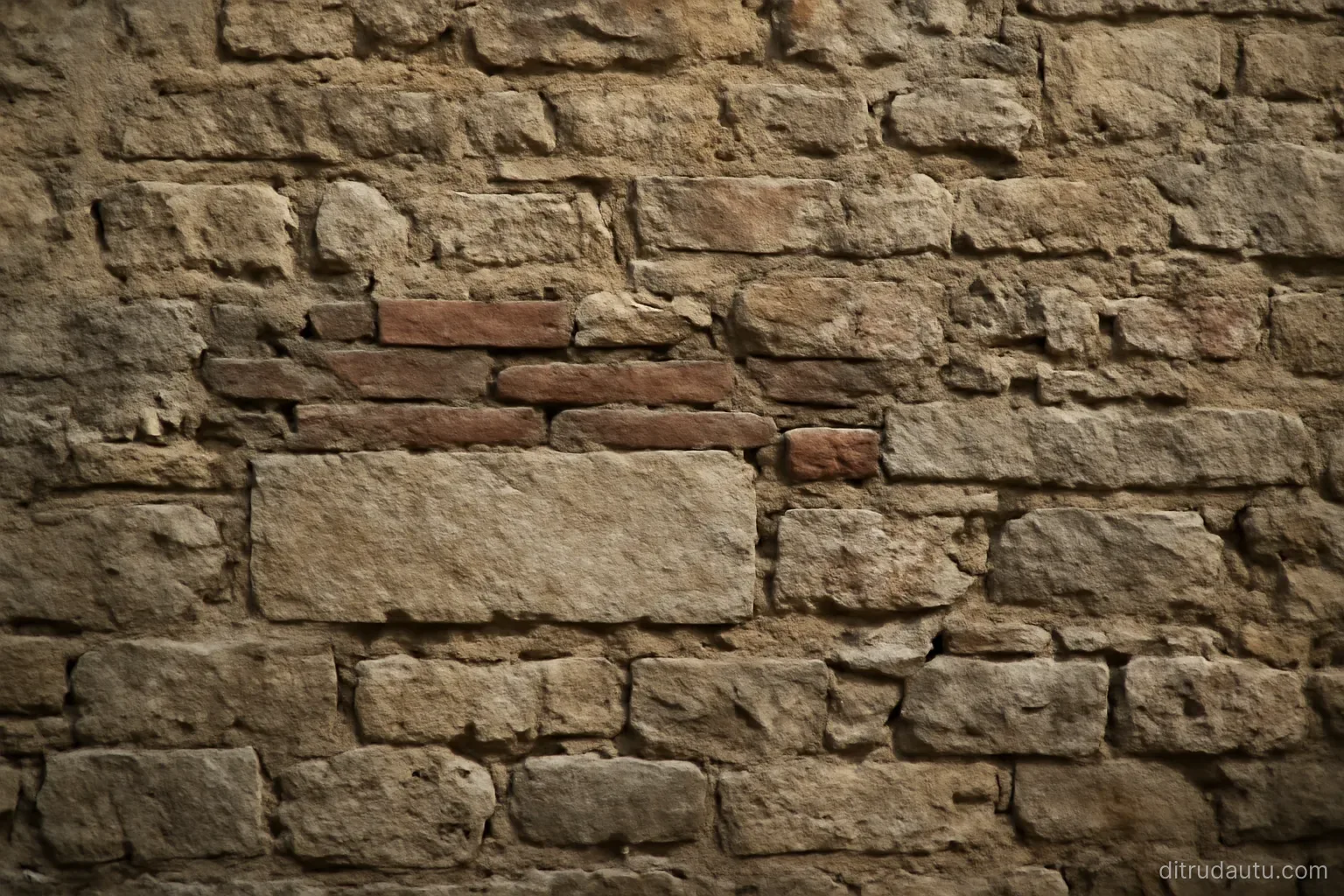 a weathered stone wall where several layers of different masonry have clearly been added on top of one another over time